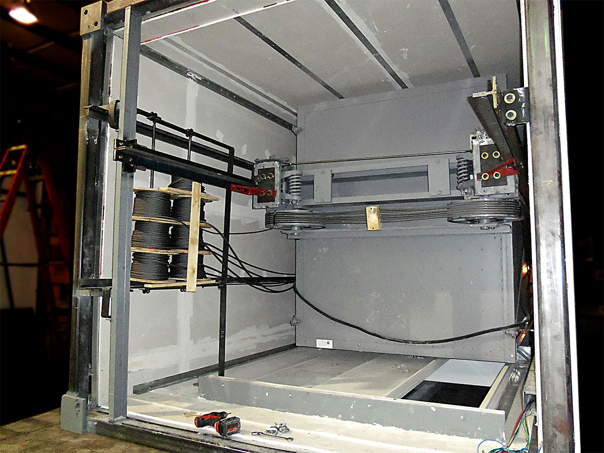 Pre-roped elevator hoistway with components
