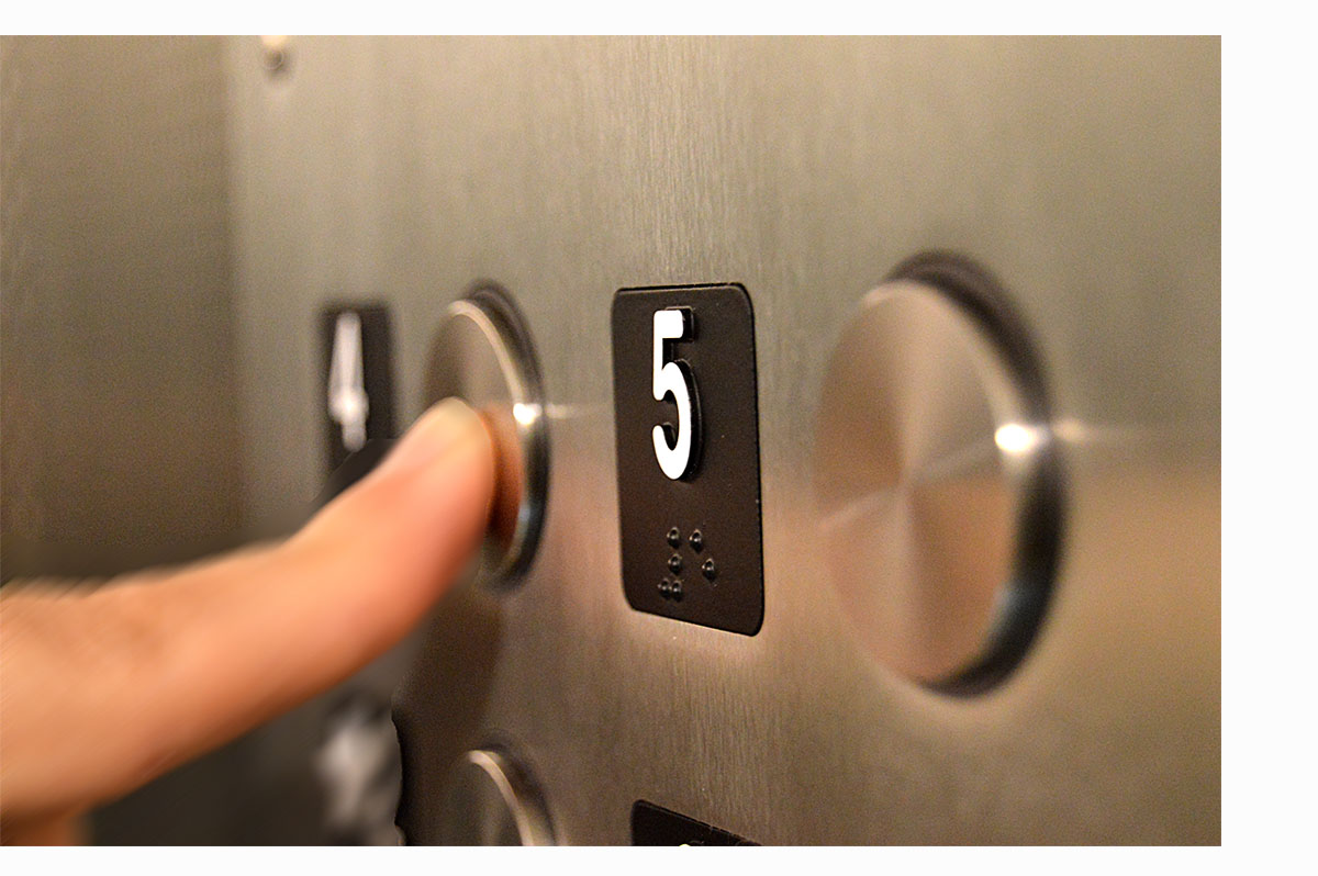 finger pushing elevator button